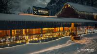 a building covered in christmas lights in the snow at Ouray Riverside Resort - Inn & Cabins in Ouray