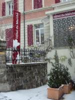 a house with a christmas tree in front of it at Hôtel du Marché in Lausanne
