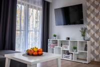 Televízia a/alebo spoločenská miestnosť v ubytovaní Trevilles Apartamenty - Green Hills