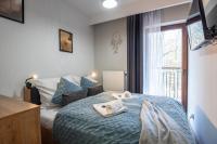 Posteľ alebo postele v izbe v ubytovaní Trevilles Apartamenty - Green Hills