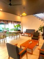 a living room with tables and chairs and a table at D'svarga Glamping in Seturan