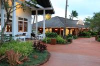 a resort building with a patio and plants at New remodeled Kiahuna Paradise condo in Koloa
