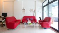 two red chairs and a table in a living room at Fu Taitung Homestay in Taitung City