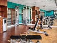 a gym with a lot of treadmills and machines at Novotel London West in London
