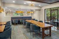 a dining room with wooden tables and blue chairs at DoubleTree by Hilton Hilton Head Island in Hilton Head Island