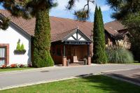 a building with trees in front of a street at Macdonald Botley Park Hotel &amp; Spa in Southampton