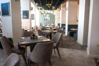 a restaurant with tables and chairs in a room at Хотел Crystal in Ruse