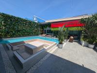 a swimming pool in front of a building at Three One East in Nong Prue