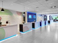 a lobby of a dental office with blue and white counters at Novotel London West in London