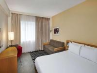 a hotel room with a bed and a couch at Novotel London West in London