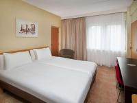 a large white bed in a hotel room at Novotel London West in London