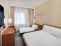 a hotel room with two beds and a window at Novotel London West in London