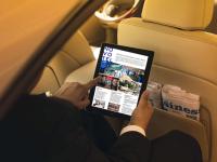 a person sitting in an airplane holding a tablet computer at Novotel London West in London