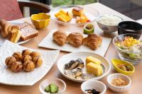 a table topped with plates of food and pastries at Henn na Resort & Spa Kansai Airport - former Henn na Hotel Kansai Airport in Izumi-Sano
