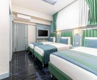 Postel nebo postele na pokoji v ubytování Santa Rio Gold Taxim Hotel