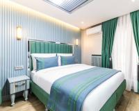 Postel nebo postele na pokoji v ubytování Santa Rio Gold Taxim Hotel