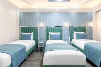 Postel nebo postele na pokoji v ubytování Santa Rio Gold Taxim Hotel