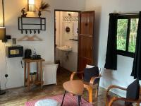 a living room with a table and chairs and a sink at Oon Lee Bungalows in Ko Jum