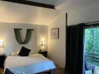 a bedroom with a bed and a large window at Oon Lee Bungalows in Ko Jum