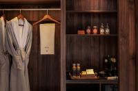 a room with a closet with a robe on a shelf at Rong Unique Hotel-Banyan Lake Scenery in Guilin