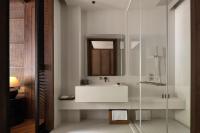 a bathroom with a sink and a glass shower at Rong Unique Hotel-Banyan Lake Scenery in Guilin
