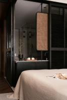a bedroom with a bed and a mirror at Rong Unique Hotel-Banyan Lake Scenery in Guilin