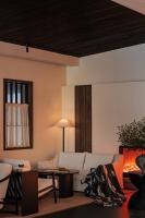 a living room with a white couch and a fireplace at Rong Unique Hotel-Banyan Lake Scenery in Guilin