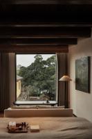 a bedroom with a large window with a view at Rong Unique Hotel-Banyan Lake Scenery in Guilin