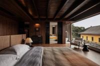 a bedroom with a large bed and a large window at Rong Unique Hotel-Banyan Lake Scenery in Guilin