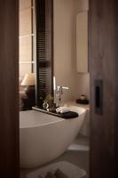 a bathroom with a white tub and a sink at Rong Unique Hotel-Banyan Lake Scenery in Guilin
