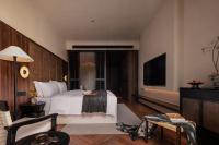 a hotel room with a bed and a flat screen tv at Rong Unique Hotel-Banyan Lake Scenery in Guilin