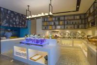 a restaurant with a counter with purple items on it at Echarm Hotel Liudong Wuling Liuqi Of Liuzhou in Luorong