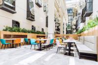 a restaurant with tables and chairs in a building at Best Boutique Hotel in Nanhui