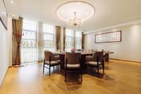 a dining room with a table and chairs and a chandelier at Best Boutique Hotel in Nanhui