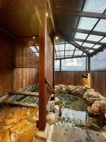 a room with a pool of water in a building at 湯布院我楽珍民泊Yufuin Garakuchin in Yufuin