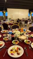 een lange tafel met borden met eten erop bij Yucel Hotel in Usak