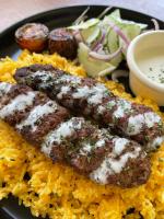 a plate of food with meat and rice and vegetables at Reef Hostel in Puerto Princesa City