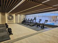 a gym with several treadmills and a swimming pool at Warsaw Presidential Hotel in Warsaw