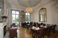 a dining room with tables and chairs and a chandelier at Odalys City Montpellier Les Occitanes in Montpellier