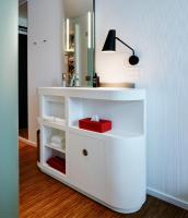 a bathroom with a white vanity with a red box at citizenM New York Times Square in New York