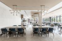 Un comedor con mesas y sillas y ventanas. en Braira Al Rass بريرا الرس, en Al Rass