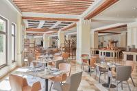 a restaurant with tables and chairs in a room at Steigenberger Aldau Beach Hotel in Hurghada