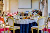 a table with chairs and a white table with fruit on it at Riad Jnane Ines in Taroudant