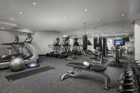 a gym with several treadmills and exercise machines at NU Hotel in Brooklyn