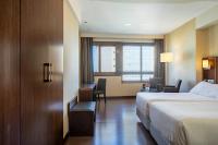 A bed or beds in a room at Hotel Coia de Vigo