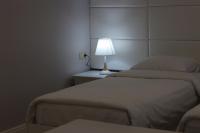 a room with two beds and a lamp on a table at Grand Hotel Kapan, Armenia in Kapan