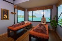a room with two beds and a mannequin in the corner at Panviman Resort Koh Phangan - SHA Extra Plus in Thong Nai Pan Noi