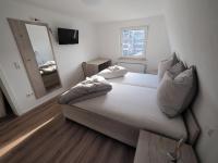 a bedroom with a large bed with a mirror and a mirror at Hotel Delphi in Heidenheim