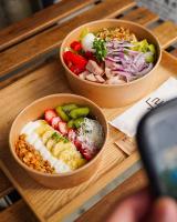 two bowls of food on a wooden table at THE ROOT2 HOTEL in Kyoto