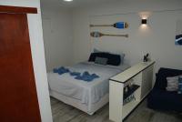 a small bedroom with a bed with blue sheets at Flat Sirena - São Vicente in São Vicente